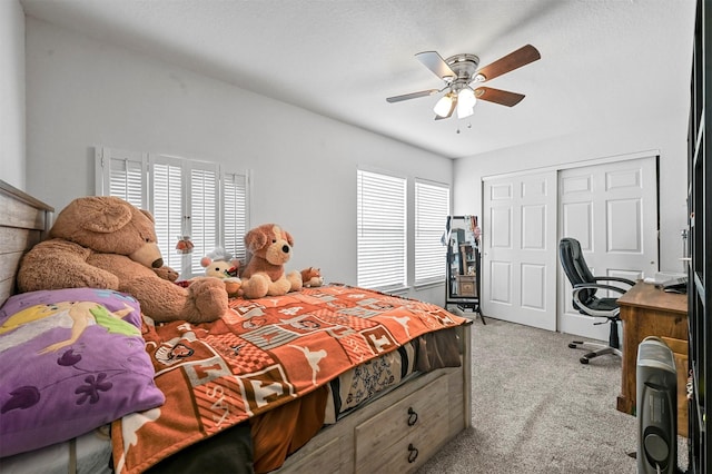 bedroom featuring ceiling fan, light colored carpet, a closet, and multiple windows