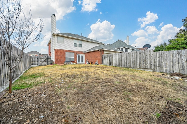 back of house featuring a yard