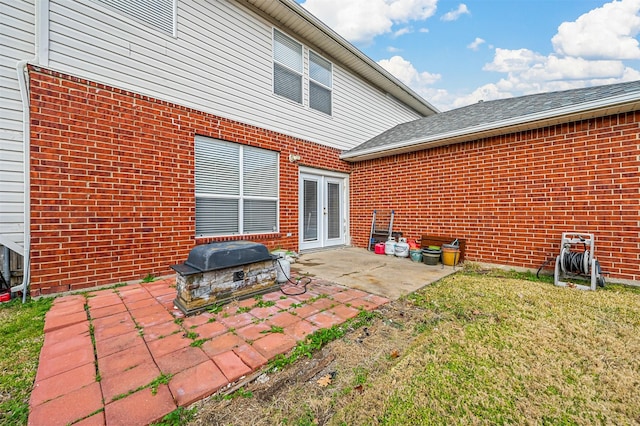 rear view of house featuring french doors, a yard, and a patio area