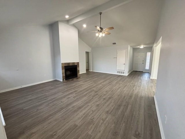 unfurnished living room with high vaulted ceiling, dark hardwood / wood-style floors, beamed ceiling, ceiling fan, and a tiled fireplace