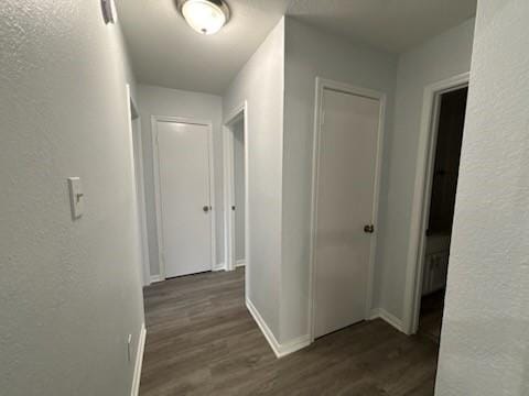 corridor featuring dark hardwood / wood-style floors