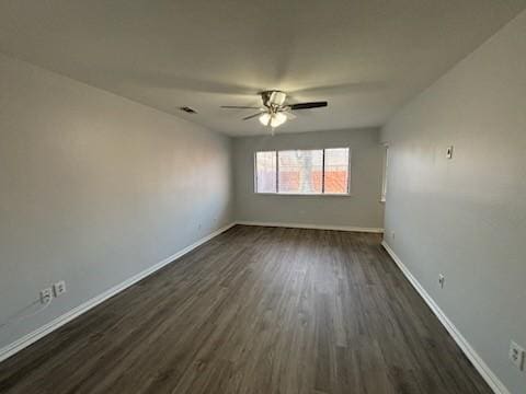 unfurnished room with ceiling fan and dark hardwood / wood-style flooring