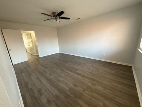 unfurnished room with ceiling fan and dark hardwood / wood-style flooring