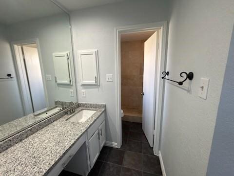 bathroom featuring vanity, tile patterned floors, and toilet