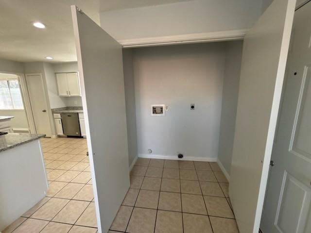 laundry area with light tile patterned flooring, hookup for an electric dryer, and hookup for a washing machine