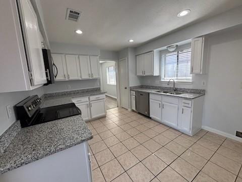 kitchen with range with electric stovetop, white cabinetry, sink, stainless steel dishwasher, and light stone counters