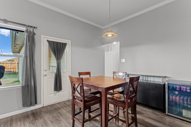 dining area featuring wine cooler, ornamental molding, and dark hardwood / wood-style floors