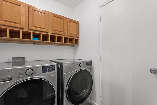 laundry area featuring cabinets and independent washer and dryer