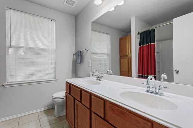 bathroom featuring tile patterned flooring, vanity, a shower with shower curtain, and toilet