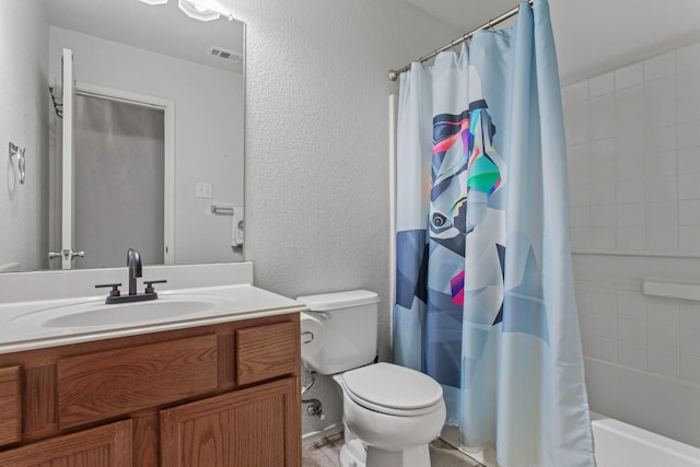 full bathroom featuring vanity, shower / bath combo with shower curtain, and toilet