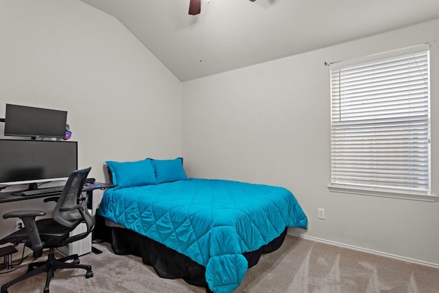 carpeted bedroom with ceiling fan and vaulted ceiling