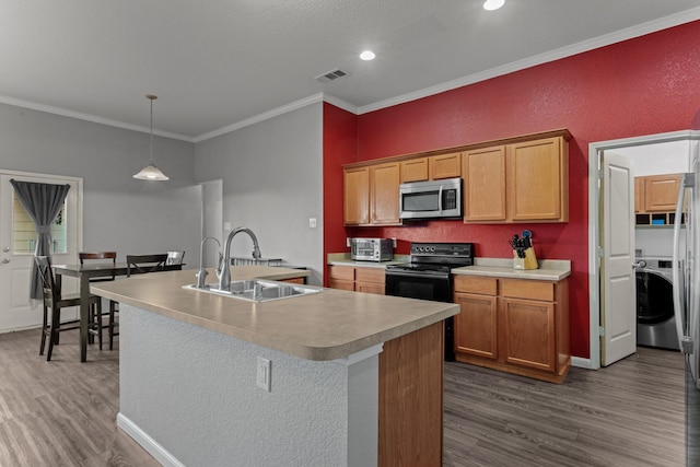 kitchen featuring washer / dryer, sink, black electric range oven, and a center island with sink