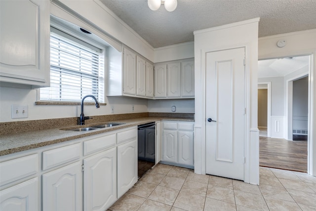 kitchen featuring white cabinetry, sink, light tile patterned floors, crown molding, and a textured ceiling