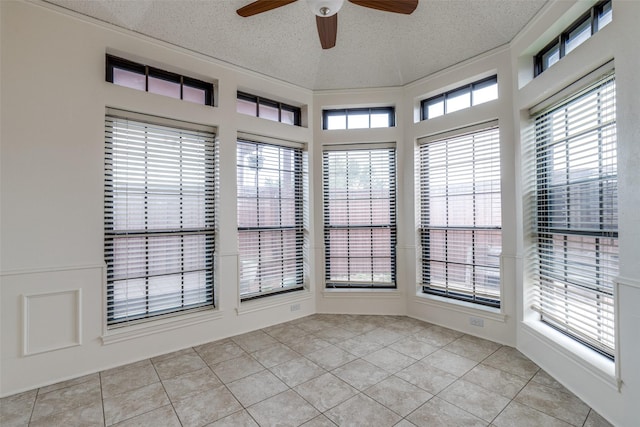 unfurnished sunroom with ceiling fan