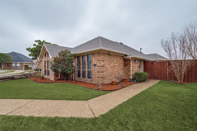 view of side of home with a yard