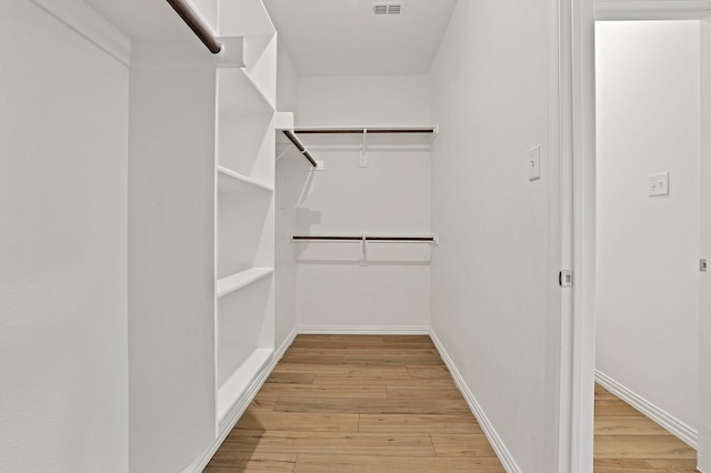 spacious closet featuring light wood-type flooring