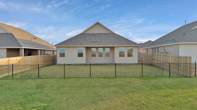 rear view of property with a yard