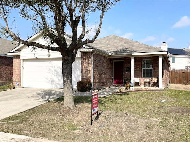 ranch-style home featuring a garage, a front yard, and covered porch