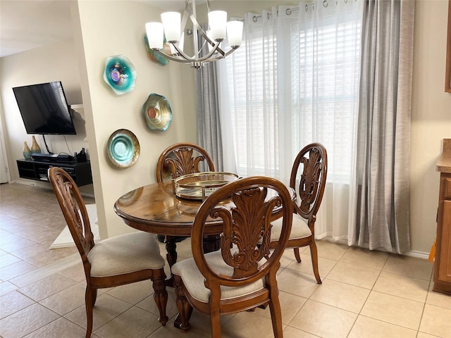 dining space with light tile patterned flooring and a chandelier