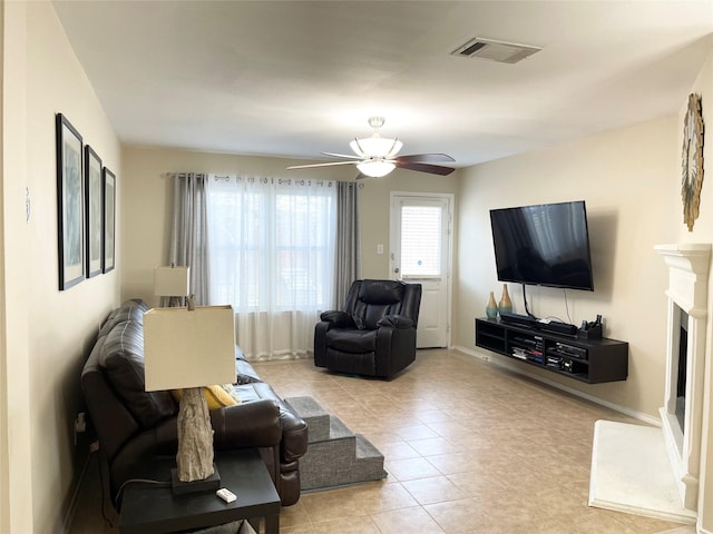 living room with ceiling fan and light tile patterned flooring