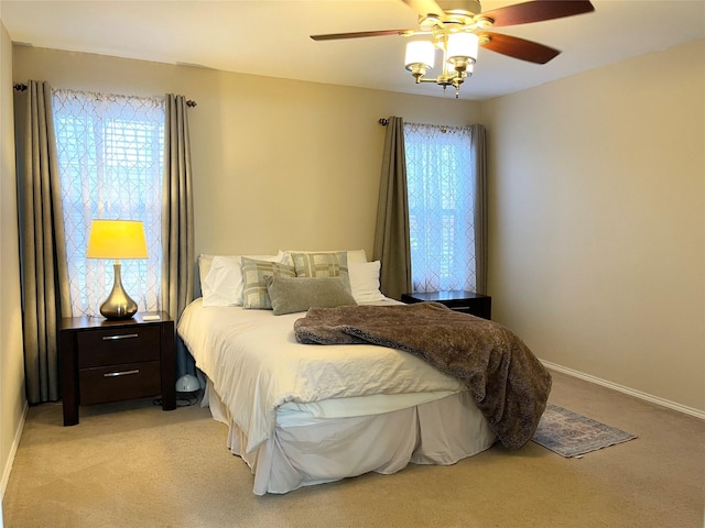 bedroom with light colored carpet and ceiling fan