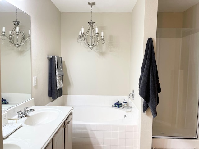 bathroom featuring plus walk in shower, vanity, and a chandelier