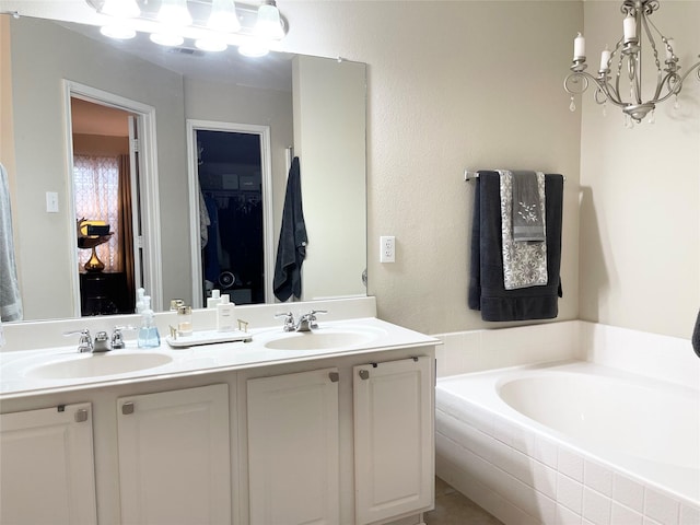 bathroom with tiled tub and vanity