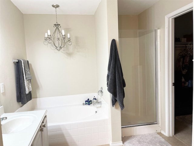 bathroom featuring independent shower and bath, vanity, and a chandelier