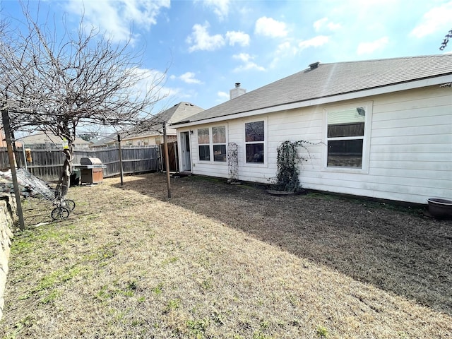 back of house featuring a lawn