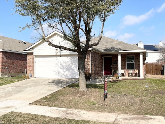 single story home with a garage, a front yard, and covered porch