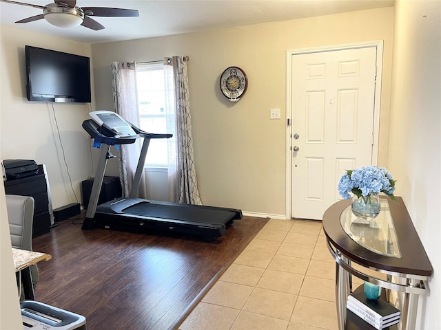 exercise room with light tile patterned flooring and ceiling fan