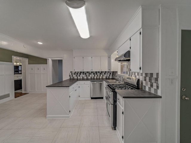 kitchen featuring sink, appliances with stainless steel finishes, white cabinetry, tasteful backsplash, and extractor fan