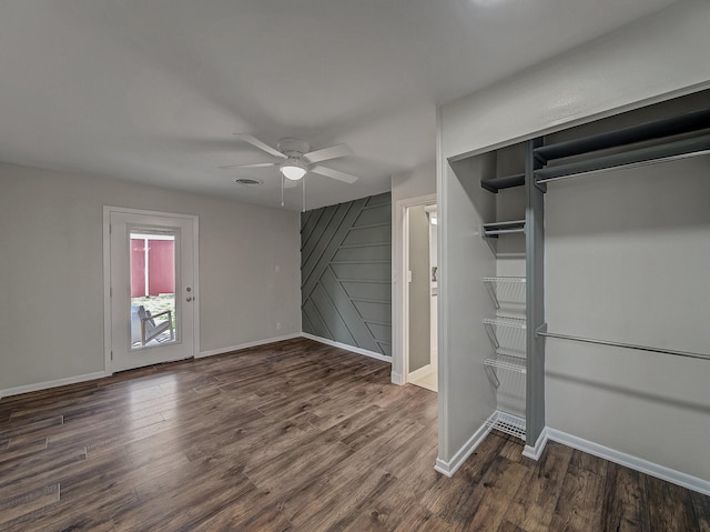 interior space with dark hardwood / wood-style flooring and ceiling fan