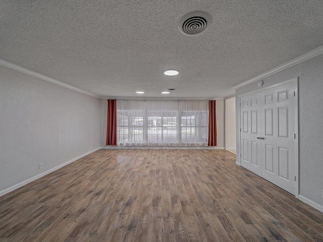 unfurnished living room featuring hardwood / wood-style flooring, crown molding, and a textured ceiling