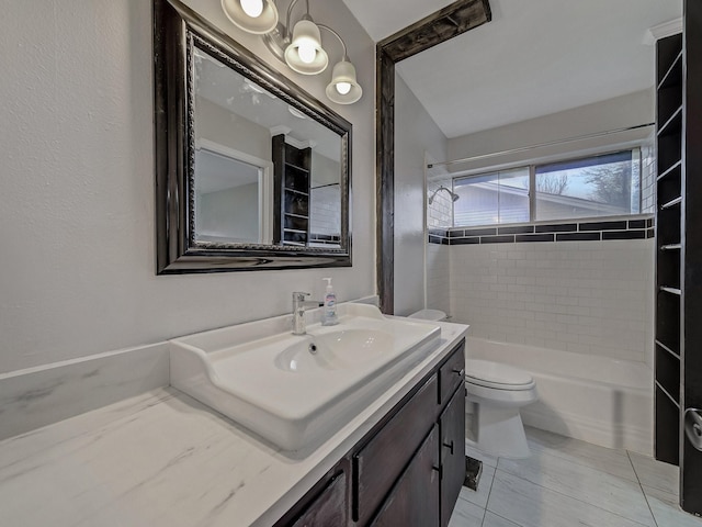 full bathroom with vanity, tiled shower / bath, and toilet