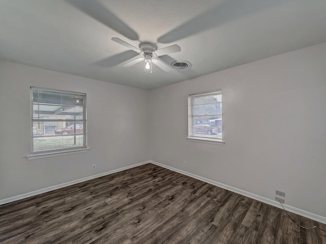 empty room featuring ceiling fan and dark hardwood / wood-style floors