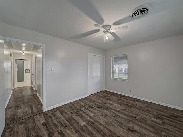 spare room with dark hardwood / wood-style floors and ceiling fan