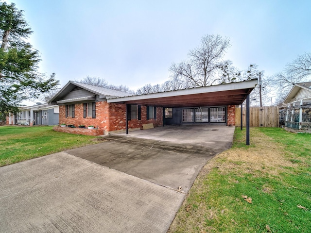 ranch-style house with a carport and a front lawn