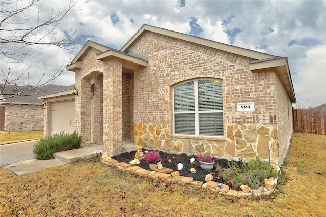 view of front of property featuring a garage and a front lawn