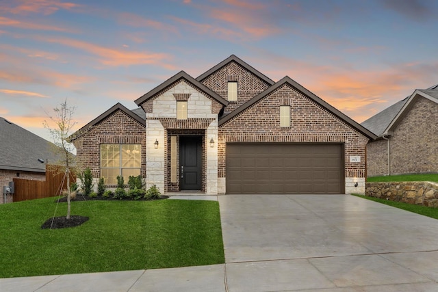 view of front of house with a garage and a lawn