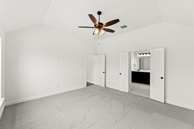 unfurnished bedroom featuring baseboards, visible vents, connected bathroom, vaulted ceiling, and carpet flooring