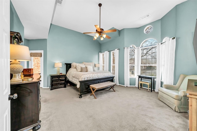 bedroom featuring vaulted ceiling, light colored carpet, and ceiling fan