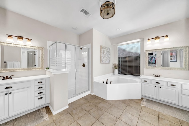 bathroom with tile patterned flooring, shower with separate bathtub, and vanity