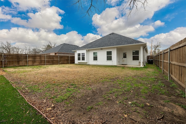 back of house featuring cooling unit and a lawn