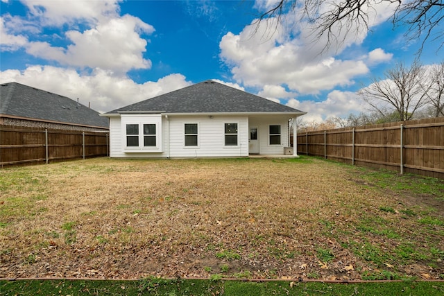 rear view of house featuring a lawn