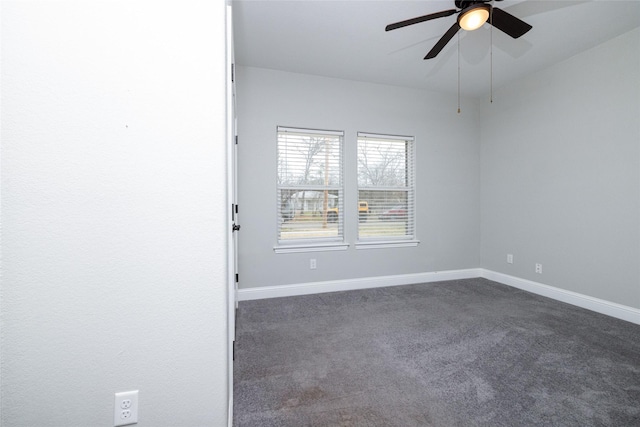 carpeted spare room featuring ceiling fan