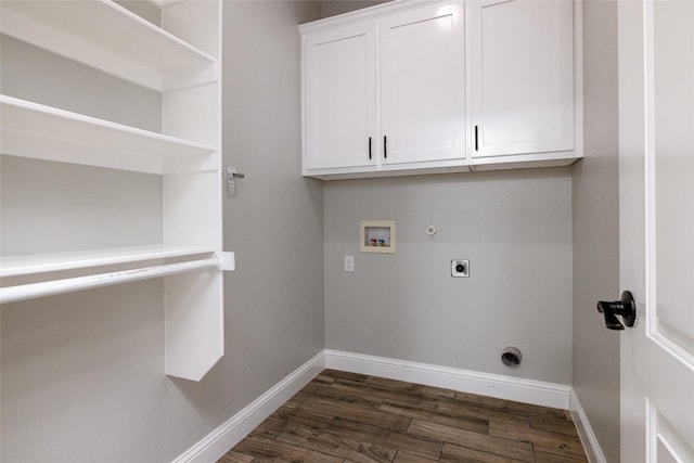 clothes washing area featuring electric dryer hookup, cabinets, dark hardwood / wood-style floors, washer hookup, and hookup for a gas dryer