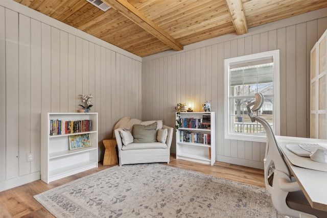 sitting room featuring beamed ceiling, wooden ceiling, and light hardwood / wood-style flooring