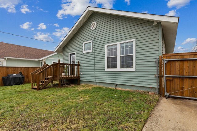 rear view of property featuring central AC, a deck, and a lawn