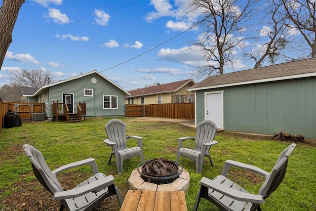 view of yard featuring central air condition unit and a fire pit